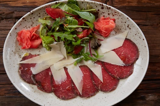 The carpaccio with cheese and salad top view.