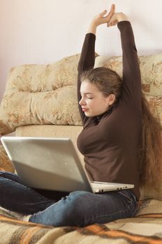 Young Cute Female Student Doing Homework in Bed. College Student Doing Homework in Bed at Home, Young Woman Preparing School Test in Bedroom. Education Concept.