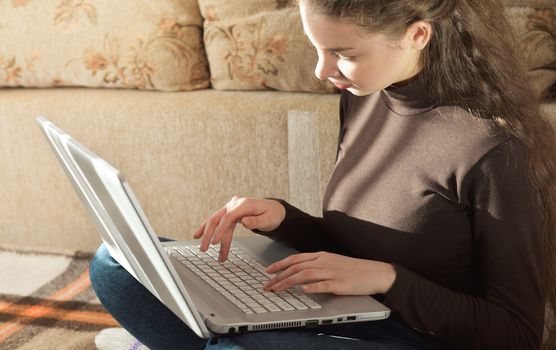 Young Cute Female Student Doing Homework in Bed. College Student Doing Homework in Bed at Home, Young Woman Preparing School Test in Bedroom. Education Concept.