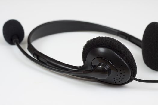 black headset with micrphone closeup  on white background