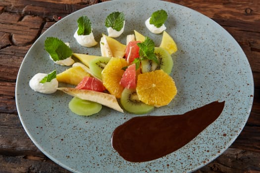 Bowl of healthy fresh fruit salad fruit with chocolate.
