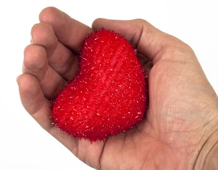 a man hand holding a small red heart on white background