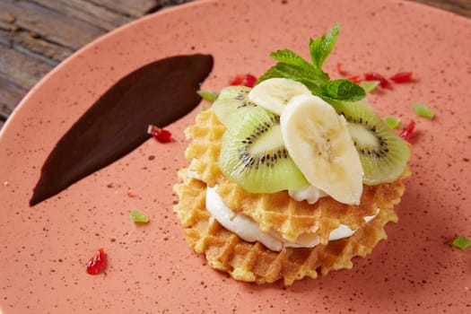 Fresh waffles with ice cream and maple syrup