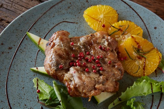 Chicken Steak with oranges and greens. Shallow dof