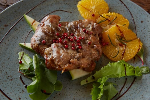 Chicken Steak with oranges and greens. Shallow dof