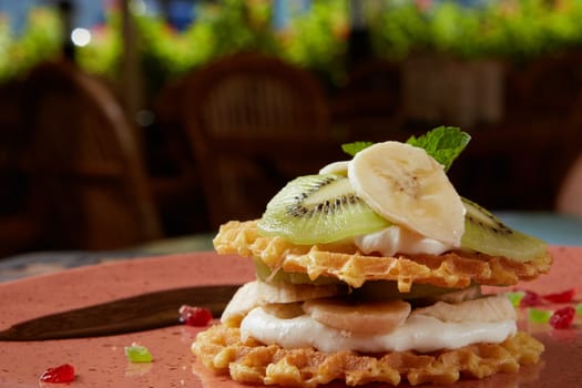 Fresh waffles with ice cream and maple syrup
