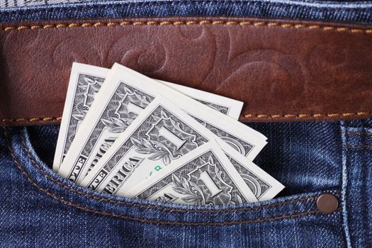 one dollar bills inside a blue jeans pocket
