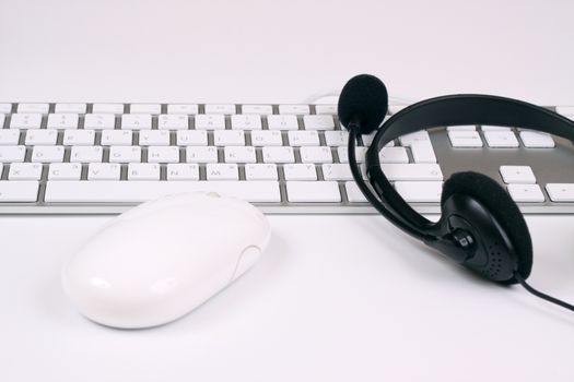 slim silver keyboard with mouse and headset on white background