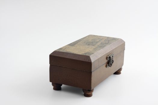 small brown wood chest with lid closed on white background