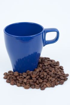 Blue coffee mug in coffee beand isolated on white background