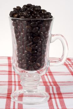 coffee beans in a glass with red pattern