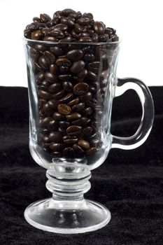 coffee beans in a glass on black and white background
