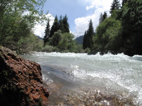 mountain river near the red stone and the extreme power of nature            