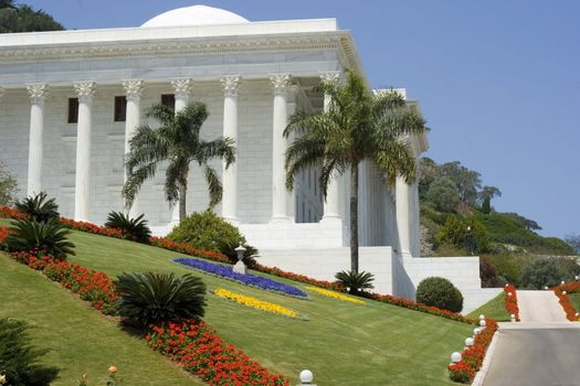 white building with garden flowers and sidewalk