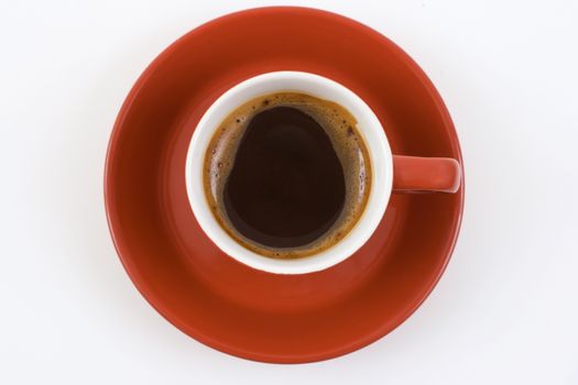 red coffee mug and plate with blak coffee 