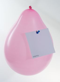 pink balloon with memo note atached with a pin