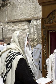 men pray at the western wall in jerusalem