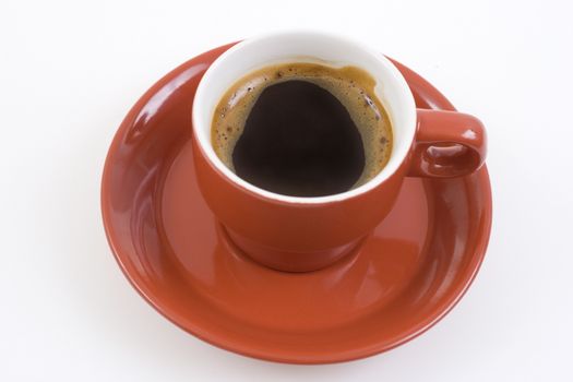 red coffee mug and plate full with coffee on white background