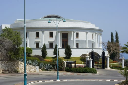 round white building with black gate and blue sky