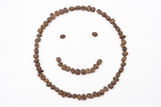 smiley face made out of coffee beans on white background