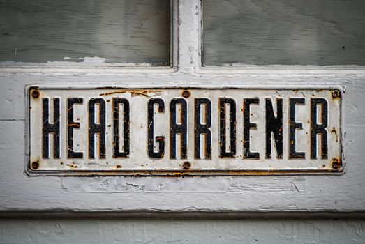 A Head Gardener's Sign On A Rustic Wooden Greenhouse Door At A Stately Home