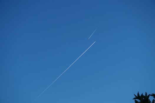 In the sky, the trace of two aircraft flying towards.