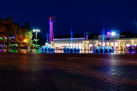 Bright colorful fountains at night on the embankment of the Amur river in the city of Khabarovsk. Bright color. Illumination of lanterns.