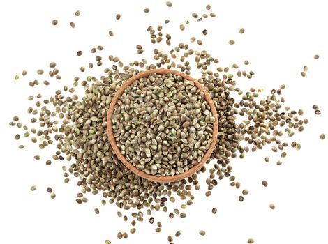 Hemp seeds in wooden bowl isolated on white background, top view