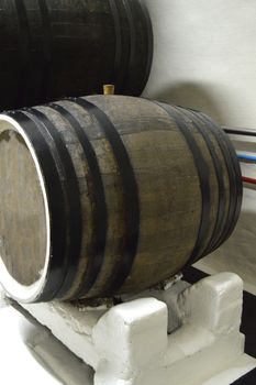 Close-up of dark oak barrels for wine storage.