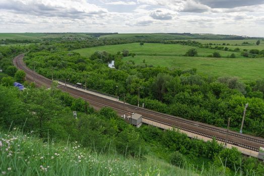 Top view of the railway tracks and a small station in the countryside in Russia.