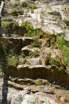 A thin stream of water on the dried waterfall Wuchang-su, Crimea June 2018.