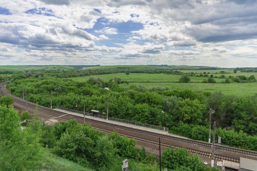 Top view of the railway tracks and a small station in the countryside in Russia.