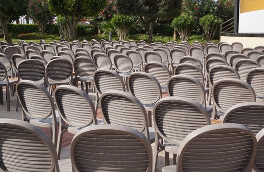 Brown chairs stand in a row in the lap of nature, the concept of a festive ceremony.