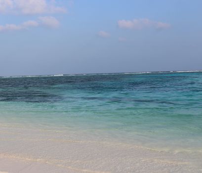 View of Clear Blue Sea Water and White Sands in Maldives Beach. Pictures taken in Day time in Male. Tropical Paradise. Use for Travel, Tourism, Concept.