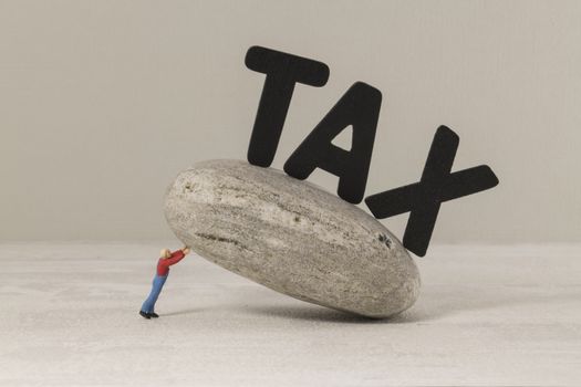 Tax concept, man collapses under the tax burden