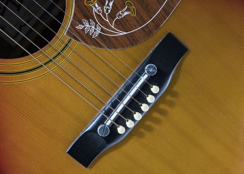 red western guitar music instrument with the strings in close up