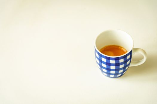 A cup of coffee with blue stripes isolated with a white background