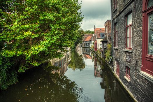 Medieval channels of Bruges, detail of tourism in a city of Belgium