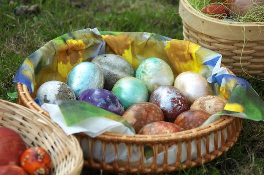 Painted eggs at Easter. Easter eggs in basket on green grass.