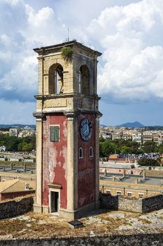 Abandoned clock tower in old fortress in Corfu with panoramic view of Corfu town at Greece.