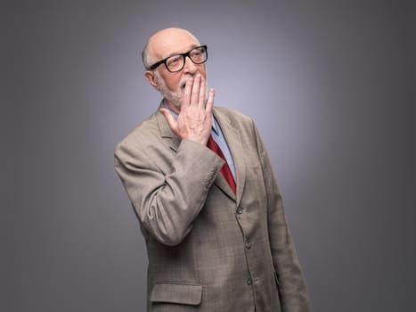 Portrait of senior caucasian yawning man . He is exhausted and tired