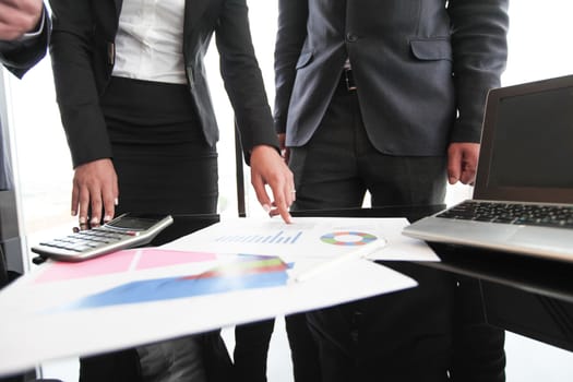 Group of people in business meeting working with documents with diagrams showing successful results