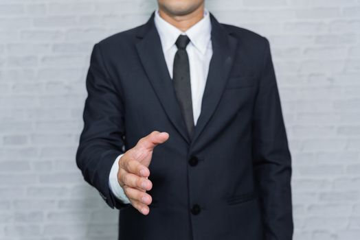 Businessman check hand on gray background