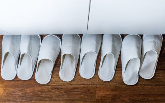 four pairs of white house slipper in the house