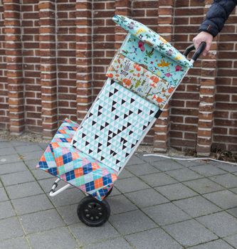 woman with a handtruck full of presents for a birthday party