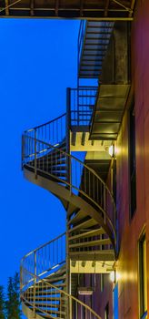 spiral staircase of a modern building, lighted at night, modern city architecture
