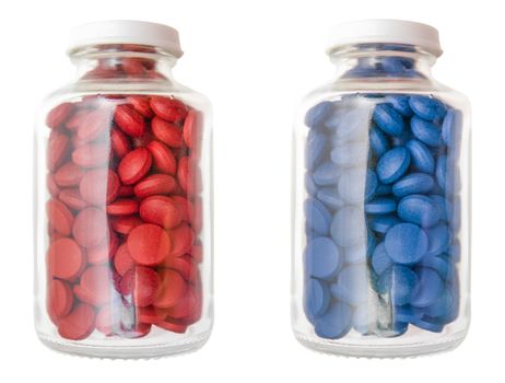 Red And Blue Pills Or Tablets In Glass Containers Isolated On A White Background