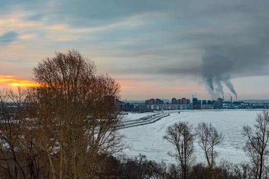 Morning view of the city of Khabarovsk in winter. Urban landscape. Frozen river. Dawn.