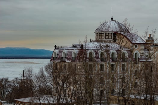 Morning view of the city of Khabarovsk in winter. Urban landscape. Frozen river. Dawn.