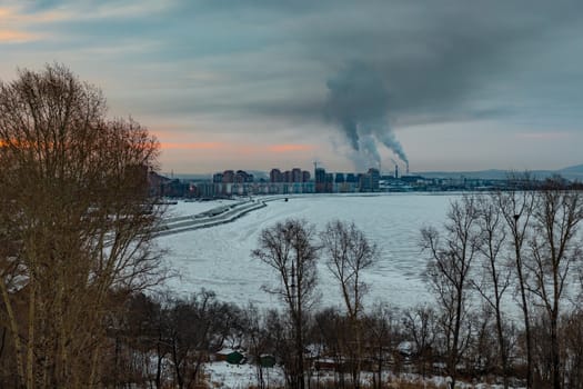 Morning view of the city of Khabarovsk in winter. Urban landscape. Frozen river. Dawn.